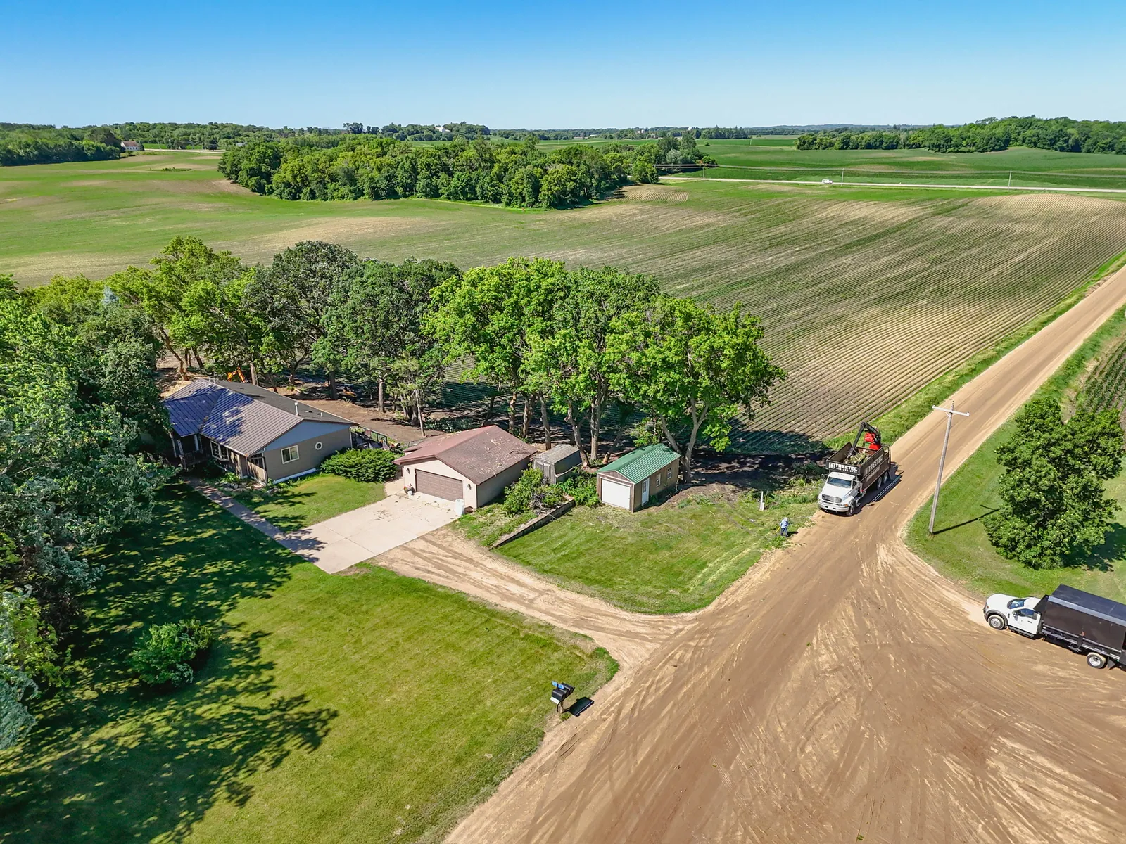 Aerial view of a TreeTec crew working a shelterbelt beside a farmstead in central Minnesota