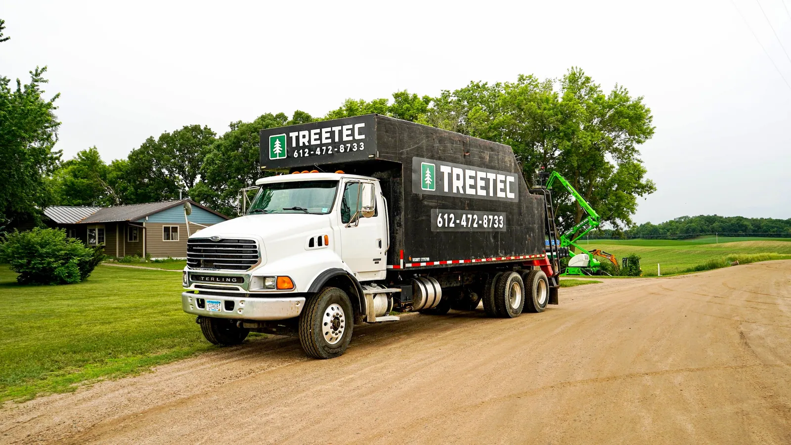 TreeTec branded grapple truck on a gravel road in central Minnesota
