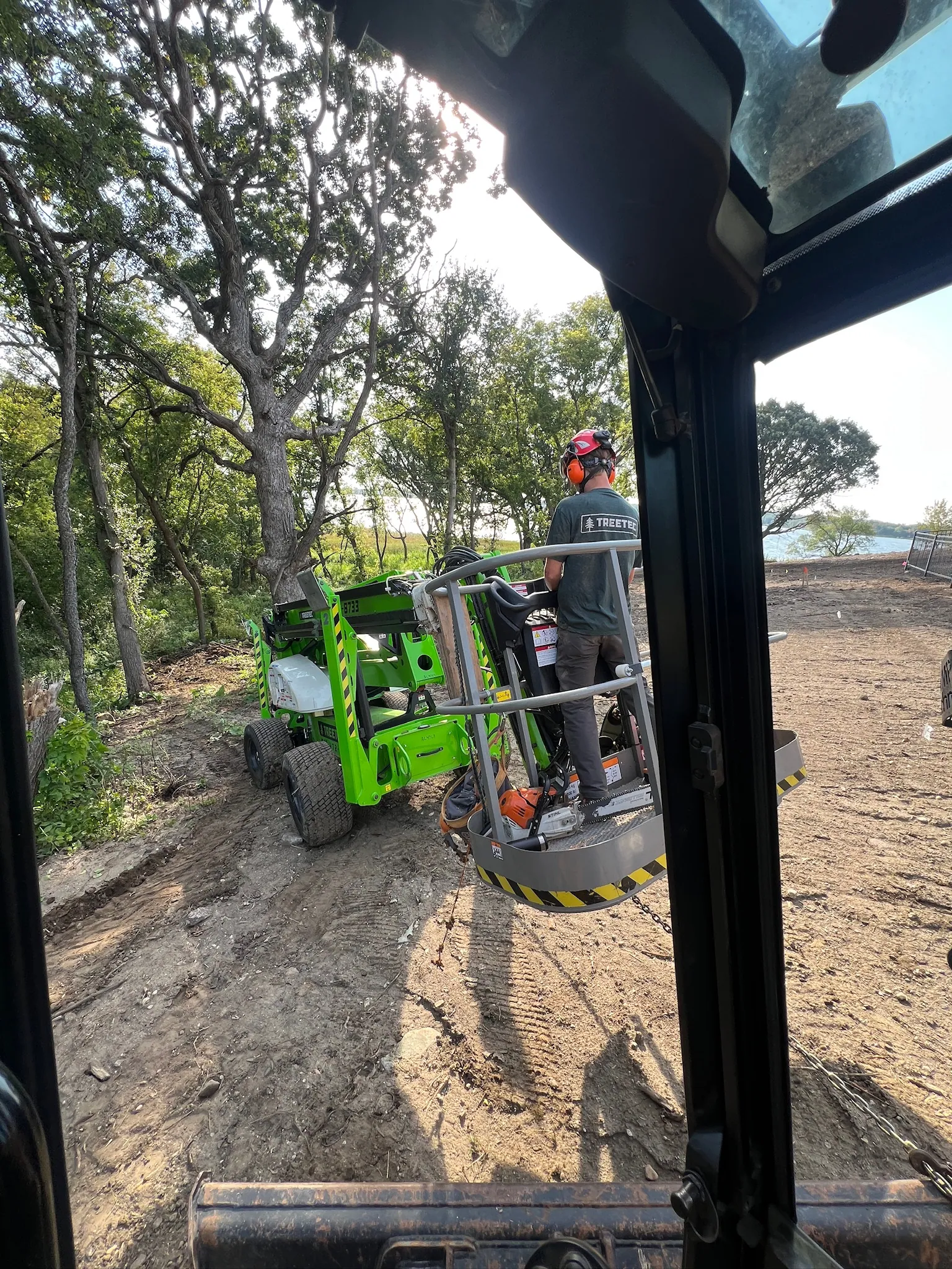 TreeTec lift clearing trees from a graded building pad near Darwin, Minnesota